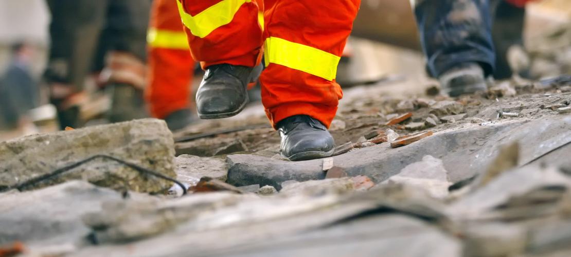 Emergency crew feet on broken road