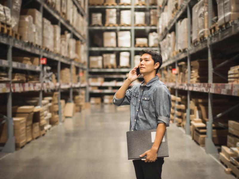 Man in warehouse on mobile phone